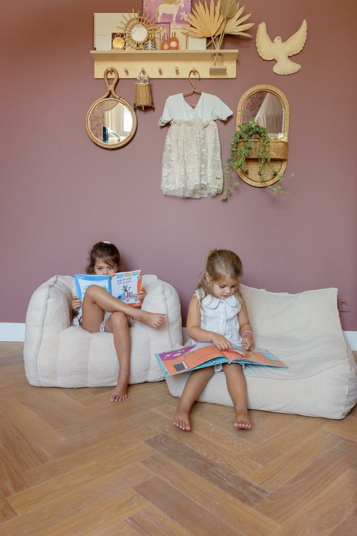 Two children enjoying the Babiem beanbag Bruno and Babiem kids chair Ella, creating a warm play space.