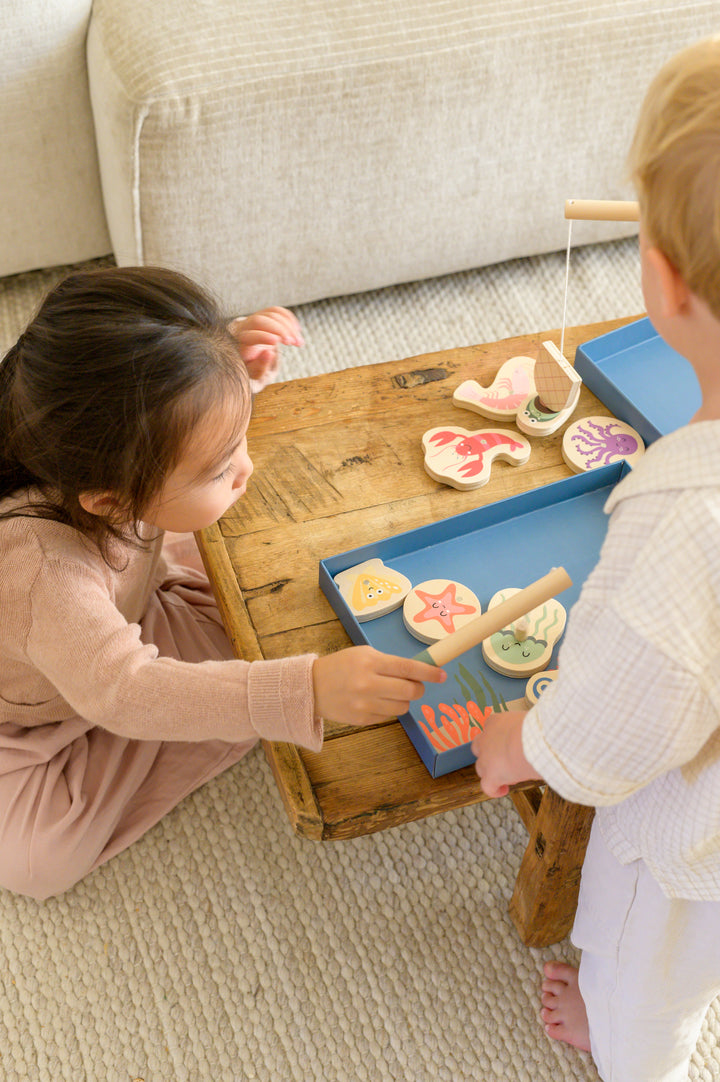 A close-up of the Babiem fishing game Emma with wooden fish and a magnetic fishing rod designed for safe and durable play.