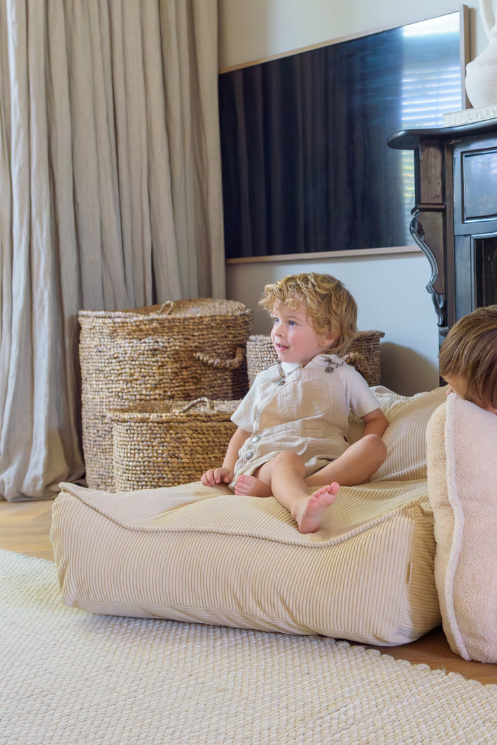 Child sitting comfortably on the Babiem beanbag Bruno, the perfect spot for rest or play.