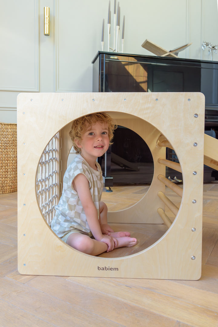 Child playing with the Babiem climbing cube Ben, designed for safe and creative climbing fun indoors.