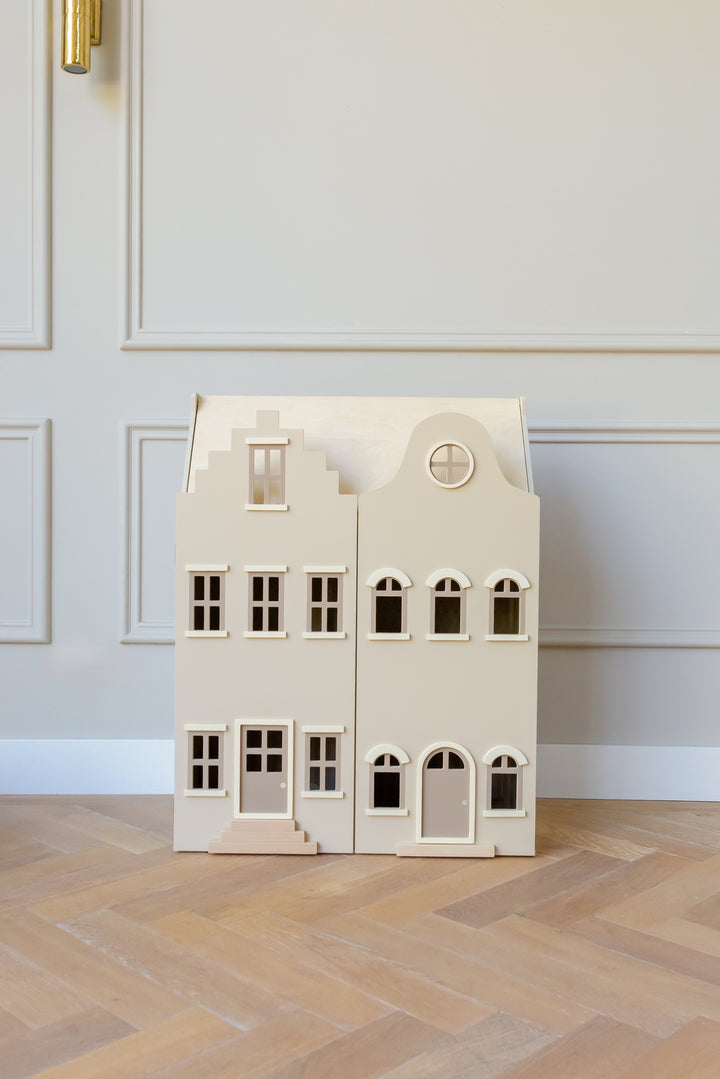 The Babiem dollhouse Lynn standing in a bright room with wooden flooring and light wall paneling.