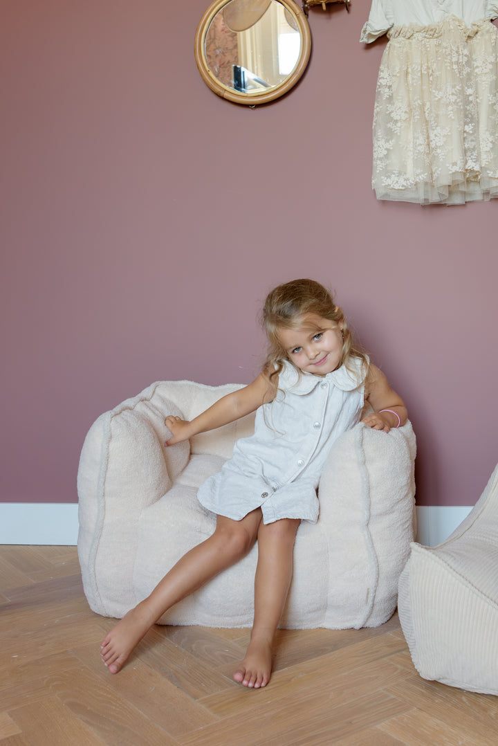 Child relaxing in the Babiem kids chair Ella, soft and cozy for every corner of the room.
