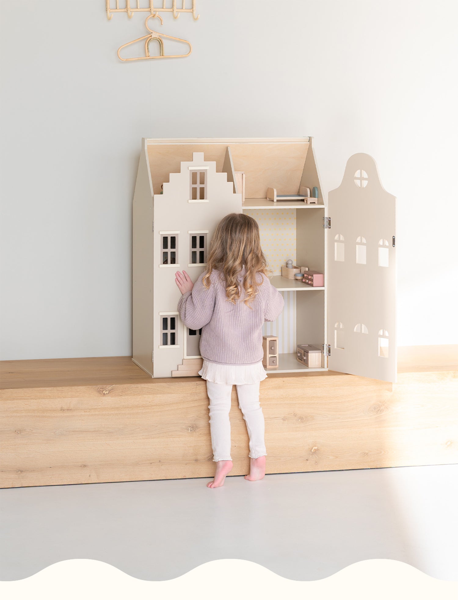 A mobile-optimized Babiem header showing a young child standing barefoot and playing with a wooden dollhouse. The minimalist setting features light wood and soft pastel tones, reflecting Babiem’s warm and natural style.
