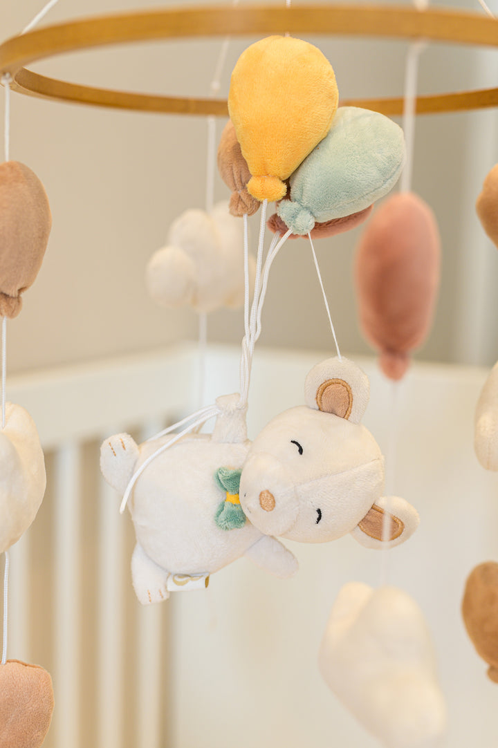 Close-up of Babiem musical mobile Sam featuring a soft plush mouse floating with pastel balloons.