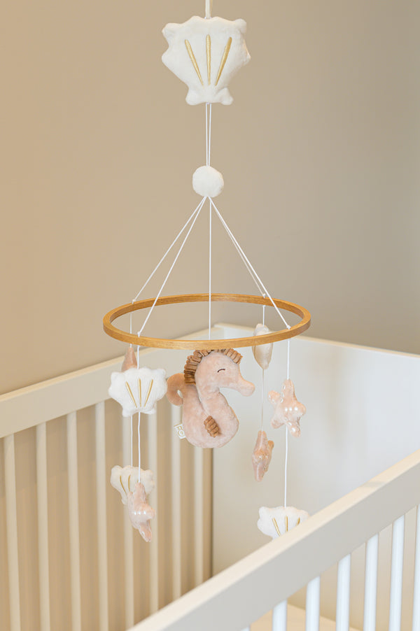 The full Babiem musical mobile Zoë featuring a plush seahorse surrounded by shells and starfish, bringing an ocean-inspired touch to the nursery.