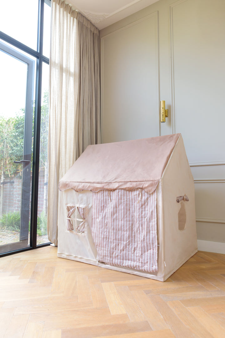 The Babiem play tent Omar placed indoors near large windows, showcasing its soft fabric walls and striped front panel.