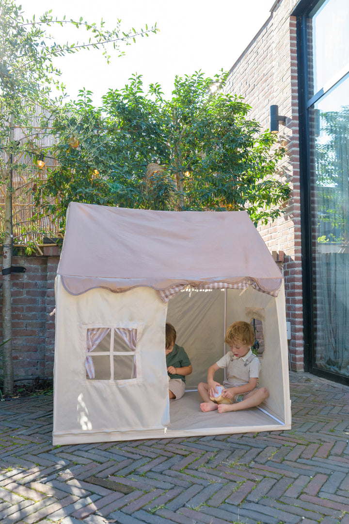 A close view of the Babiem play tent Omar with children inside, featuring beige fabric walls, a window with curtains, and a soft roof design.