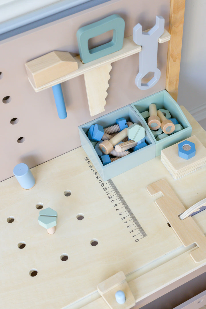 Close up of wooden screws bolts and accessories on Babiem toolbench Thomas educational toy