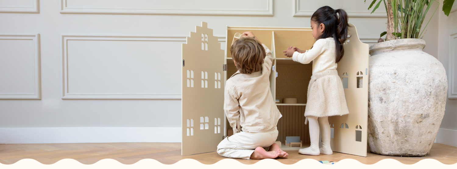 Children playing with a wooden dollhouse by Babiem, designed for imaginative and mindful play in a calm, natural interior.