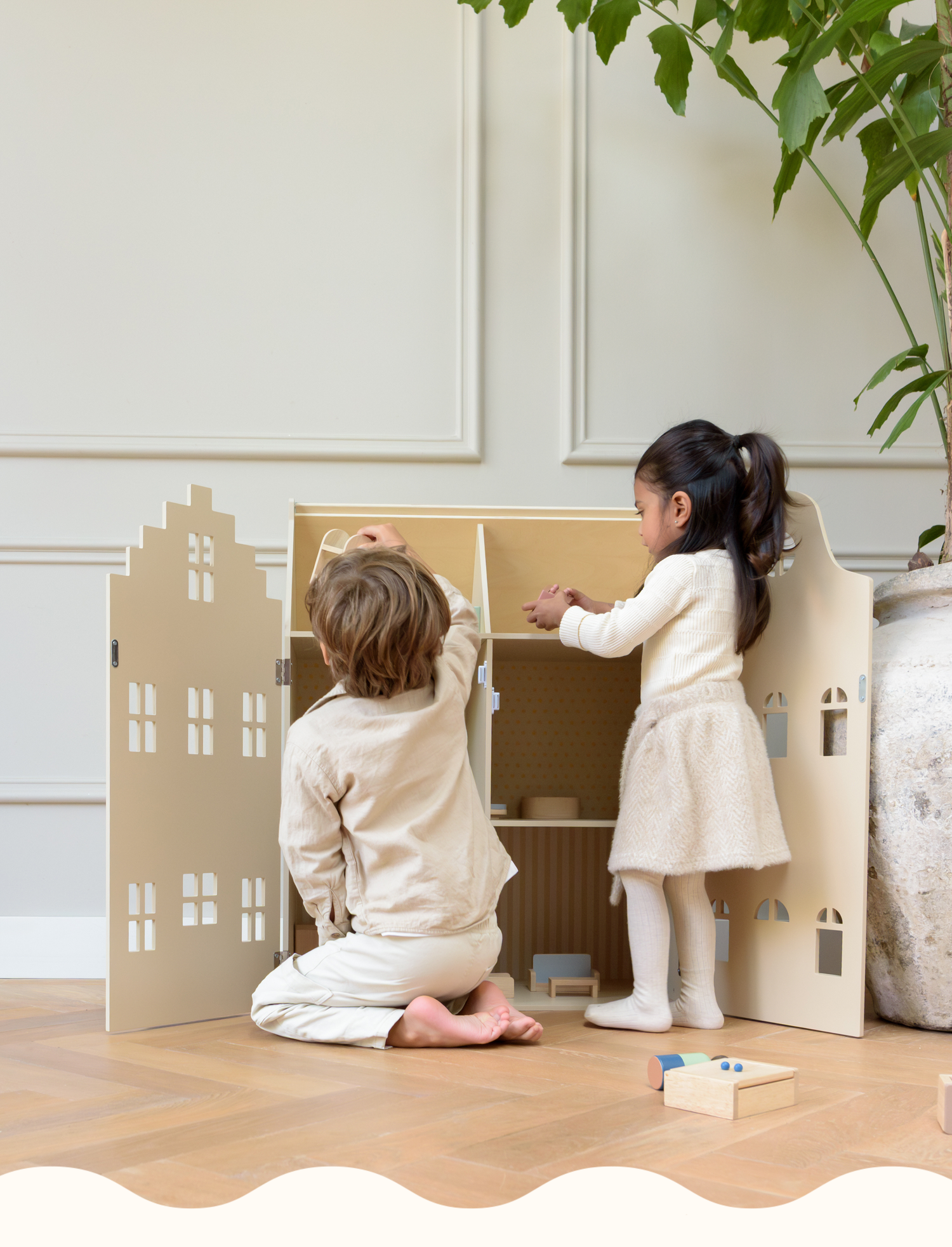 Children playing with a wooden dollhouse by Babiem, designed for imaginative and mindful play in a calm, natural interior.