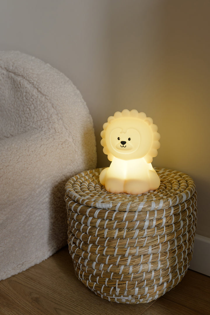 The Babiem Lucas lion-shaped night light glowing with a soft yellow light, adding comfort and warmth to a cozy children’s corner.
