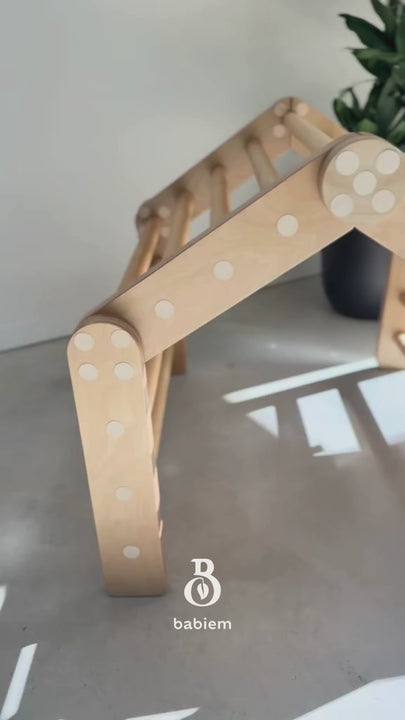 A professional product shot of the Ben climbing house and slide set. The wooden play structure features a sturdy climbing house connected directly to a sleek slide, showcasing its seamless modular design and natural finish.